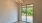 Dining room with gold chandelier and walkout patio